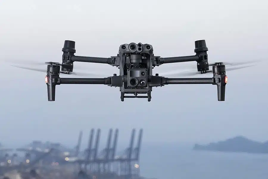 matrice 30t volando sobre cielo nublado y una fabrica de fondo